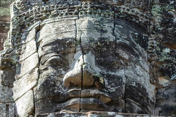 Beautiful face sculptures at the famous Bayon temple in the Angkor Thom temple complex, Siem Reap, Cambodia