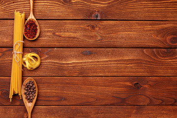 Wall Mural - dried pasta on wooden background