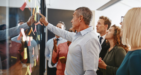 Wall Mural - Diverse businesspeople brainstorming together with sticky notes