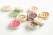 © Erlantz - Wooden buttons with colorful stripes and colorful dots on a white background