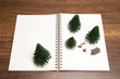 Two miniature camping with pine tree on white blank notebook