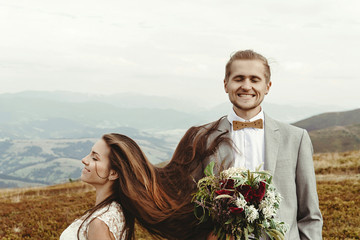 Wall Mural - gorgeous bride and stylish groom  having fun, boho wedding, luxury ceremony at mountains