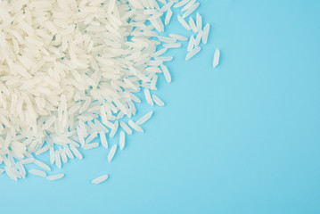 Wall Mural - White rice isolated on blue background on top view food object design