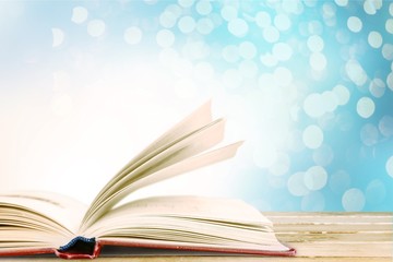 Wall Mural - open book on old wooden table.