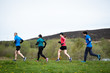 © Stephen Davies - Group of people of mixed ages running together outside, preparing for the marathon