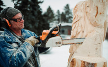Artist Carving A Wood Sculpture With Chainsaw; Edmonton, Alberta, Canada
