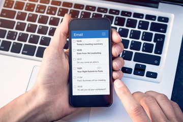 email app on smartphone screen with business person reading messages from inbox with wireless intern
