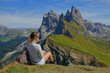 © helivideo - CLOSE UP: Hiker taking in the spectacular views of the Dolomites on sunny day.