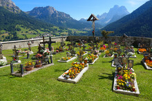 Colorful Flowers And Ornaments Liven Up The Dreary Graveyard In Sunny Mountains.