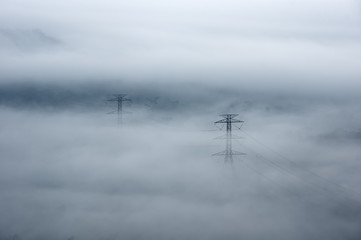 Wall Mural - electric transmission towers in fog