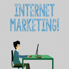 Text sign showing Internet Marketing. Business photo showcasing drive direct sales of products via electronic commerce Businessman Sitting Straight on Chair Working on Computer and Books on Table