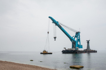 a large floating crane saves a barge aground in Odessa