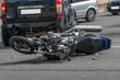 © yaroslav1986 - broken motorcycle closeup beside the car. an accident on the road in the city on a sunny day involving a motorcycle and a car.