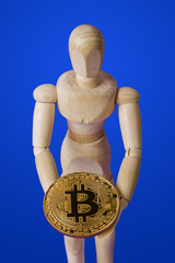 Canvas Print - Wooden toy figure with bitcoin on blue