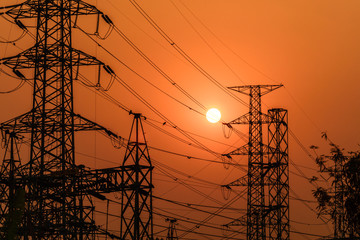 high voltage steel transmission tower during sunset