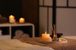 © New Africa - Burning candles and aromatic reed freshener on table in spa salon, space for text
