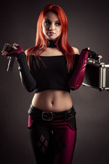 beautiful woman with case and gun in hands