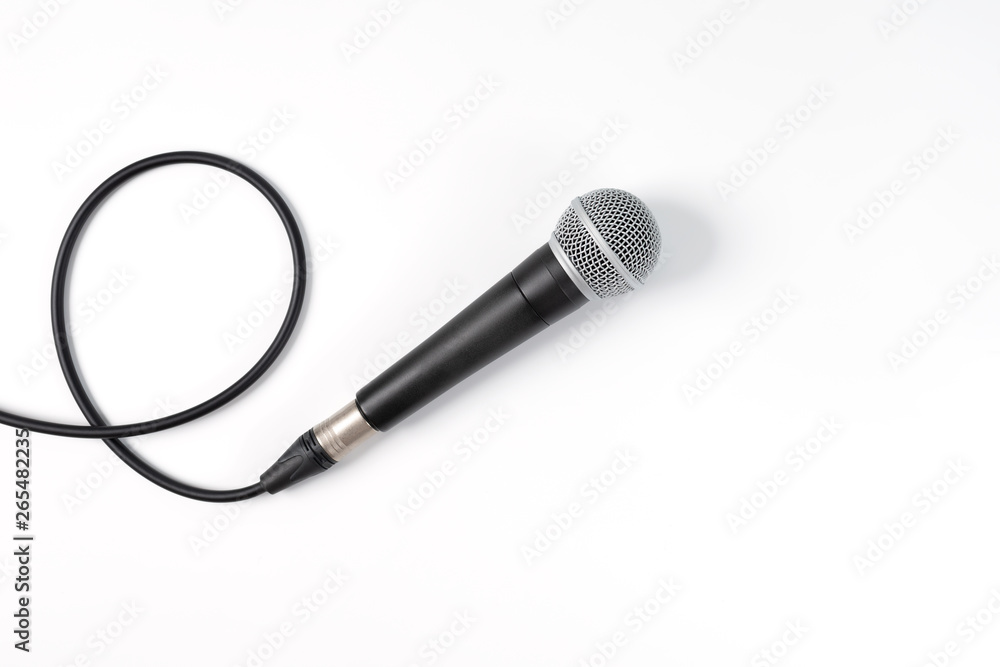Microphone on white background with clipping path . Close up of dynamic microphone connect with male xlr connector and  cable isolated on white background,top view. - obrazy, fototapety, plakaty 