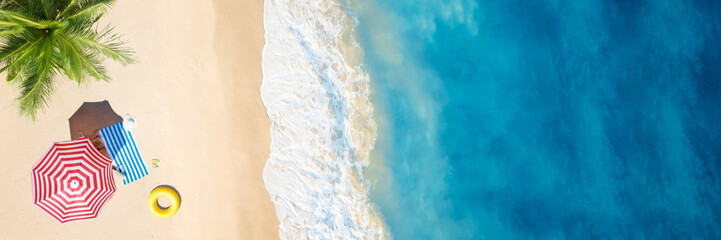 Wall Mural - aerial view of umbrella,towel on sand beach