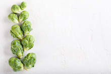 Fresh Raw Organic Brussels Sprouts On White Background. Top View, Flat Lay, Copy Space.