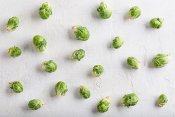 Fresh raw organic brussels sprouts on white background. Top view, flat lay.