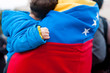 detail of little child hand on venezuelan flag as symbol of hope in future regime change, during march in support of Guaido government