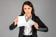 girl or businesswoman tearing a piece of paper on a gray background