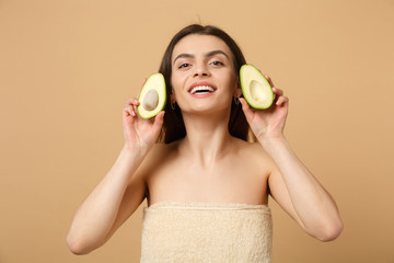 Wall Mural - Close up brunette half naked woman 20s with perfect skin nude make up hold avocado isolated on beige pastel wall background studio portrait. Healthcare cosmetic procedures concept. Mock up copy space.