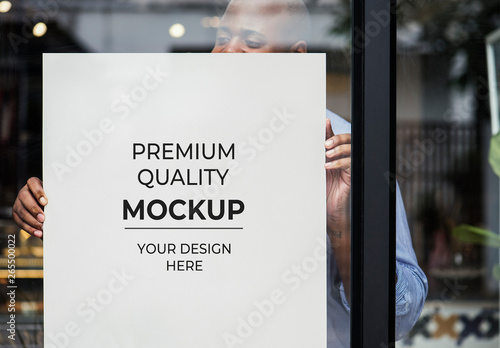 Download Person Putting Poster Mockup In Shop Window Stock Template Adobe Stock