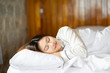 © 220 Selfmade studio - Beautiful Attractive Asian woman wearing Pajamas sleep close her eyes smile sleep and sweet dream on bed in bedroom in the morning feeling so relax and comfortable,Healthcare and Sleep Concept