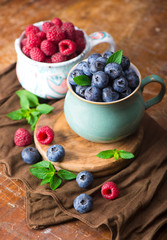 Sticker - blueberries and raspberries on a wooden background