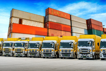 Wall Mural - Row of Cargo vehicles and containers. Freight transportation. Cargo truck park.