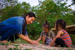 © Nutt - Lifestyle portrait mom son and daughter  playing with sand, Funny Asian family in a park