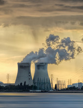 Riverbank With Nuclear Power Plant Doel During A Sunset With Dramatic Cluds, Port Of Antwerp, Belgium