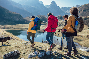 Group of hikers walking on a mountain at autumn day