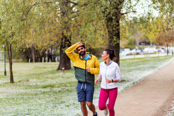 Active couple running together outdoor at park