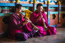 Asian Monks Playing Instruments On Temple Floor