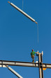 © Mint Images - Rear view of construction worker on scaffolding