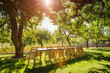 © Mint Images - Folded chairs leaning on table in backyard