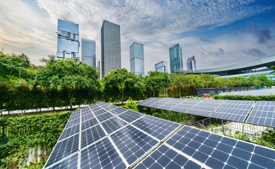 Wall Mural - solar panels with cityscape of modern city,ecological energy renewable concept.