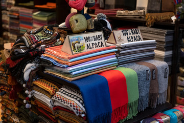 Wall Mural - Colorful Peruvian handmade scarf made from baby alpaca fabric traditional of Andean cultures for sale at street Indian market in Miraflores, Lima.