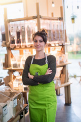 Wall Mural - Portrait of a young woman arms crossed, owner of her food store. 