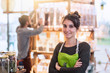 © jackfrog - Portrait of a young woman arms crossed, owner of her food store.