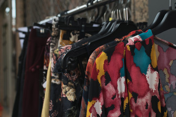 vintage clothes hanging on rack in a street flea market.