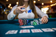 © RomanR - Female hands holding piles of casino chips on table