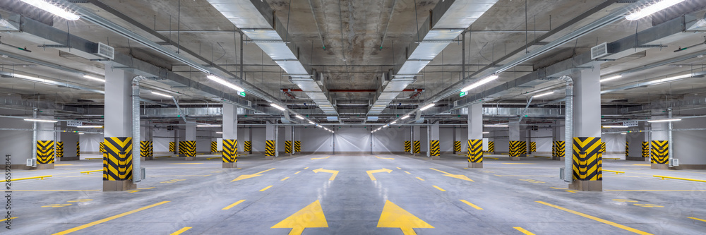 Empty shopping mall underground parking lot or garage interior with concrete stripe painted columns - obrazy, fototapety, plakaty 