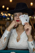© RomanR - Young lady in casino with four aces