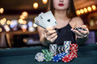 © RomanR - Young lady in casino with four aces