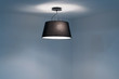 © Siraphatphoto - Modern Ceiling lamp hanging in the empty room.