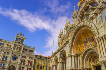 Wall Mural - The Patriarchal Cathedral Basilica of Saint Mark and The Clock Tower at the Piazza San Marco - St Mark's Square, Venice Italy. The exterior of the west facade of Saint Mark's Basilica. 